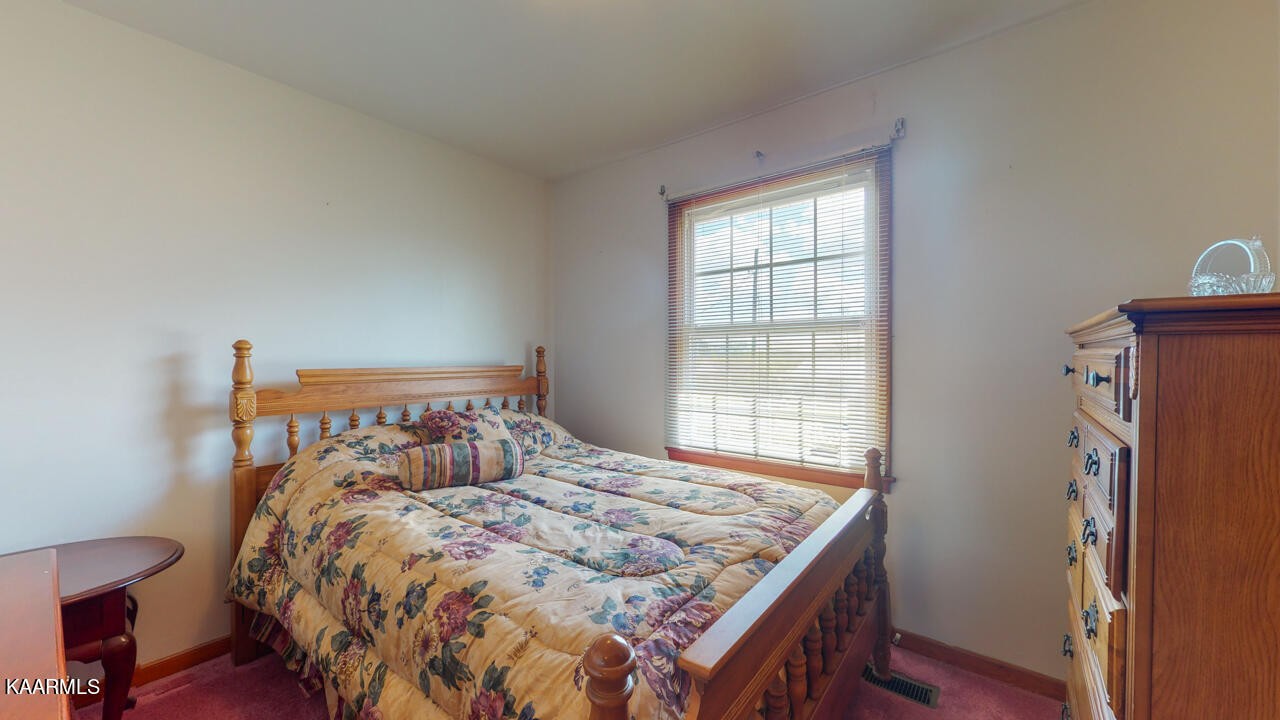 5409 Bluefield Road Knoxville, TN 37921 - Photo 25 of 33 a bed sitting in a bedroom next to a window