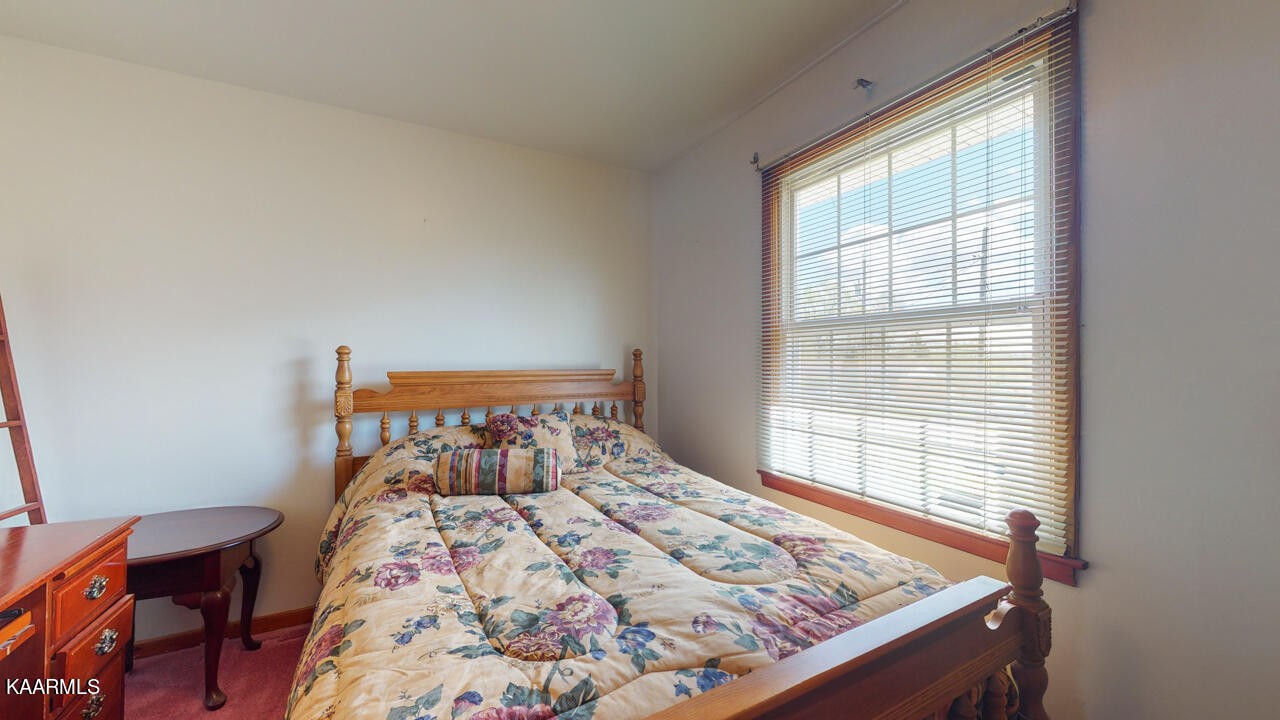 5409 Bluefield Road Knoxville, TN 37921 - Photo 27 of 33 a bed sitting in a bedroom next to a window
