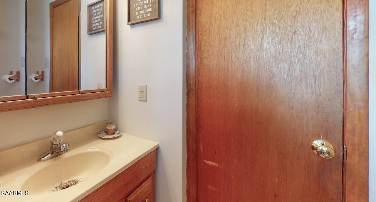 5409 Bluefield Road Knoxville, TN 37921 - Photo 29 of 33 a bathroom with a sink and a mirror