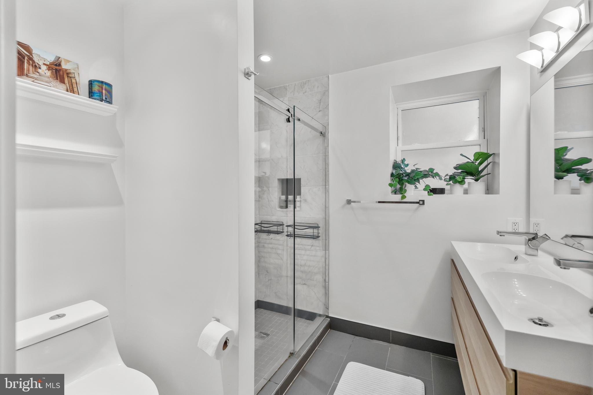 1324 W Street Northwest, Unit 1 Washington, DC 20009 - Photo 24 of 37 a bathroom with a sink toilet and shower