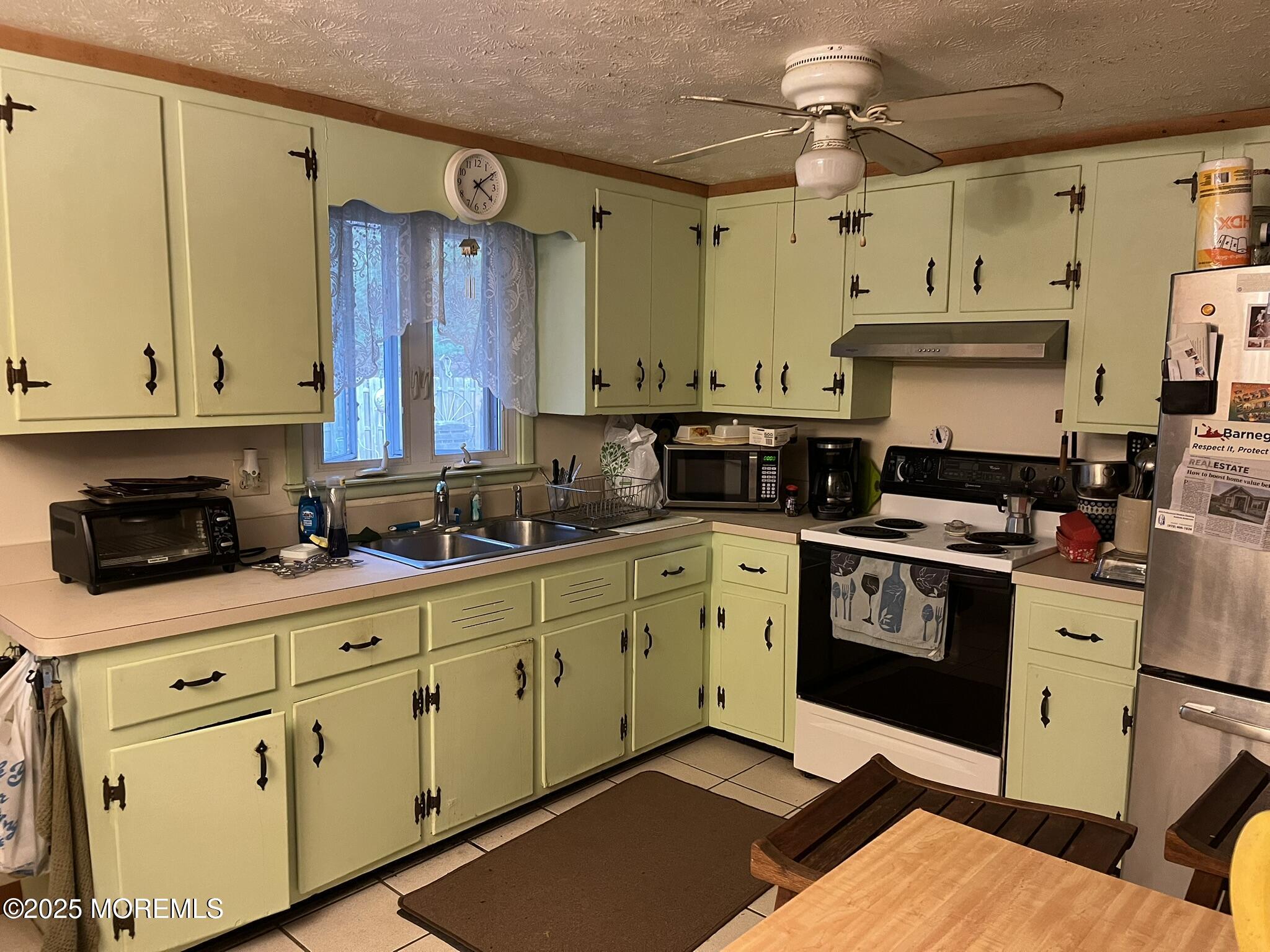 860 Highway 72 Barnegat, NJ 08005 - Photo 6 of 9 a kitchen with stainless steel appliances granite countertop a stove a sink and white cabinets