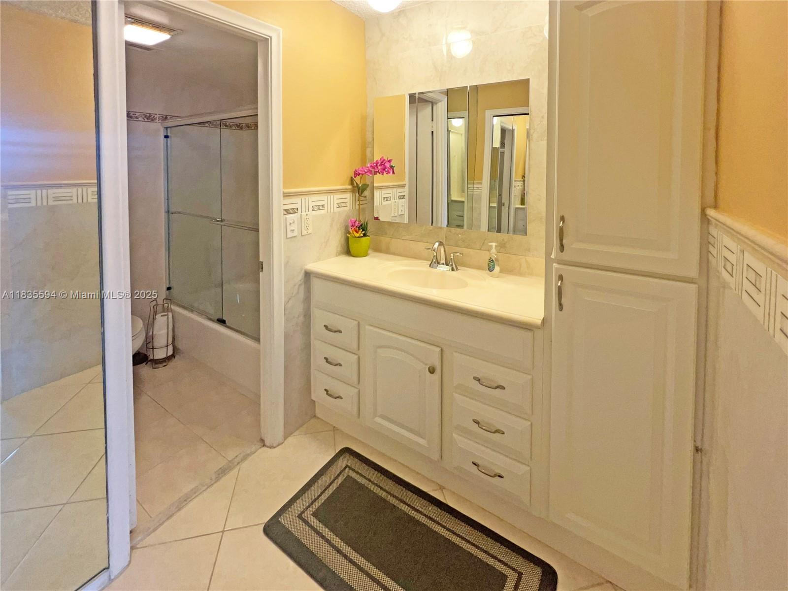 2000 South Ocean Boulevard, Unit 16P Lauderdale-by-the-Sea, FL 33062 - Photo 12 of 31 a bathroom with a granite countertop sink a mirror and a shower