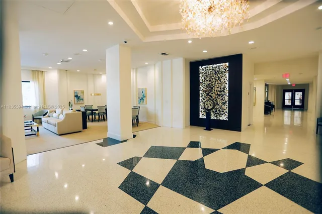 a lobby with a rug and glass door