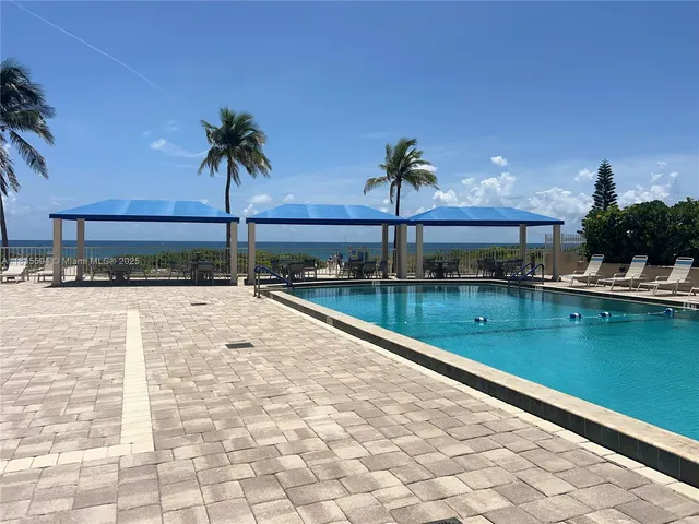 a view of swimming pool with outdoor seating