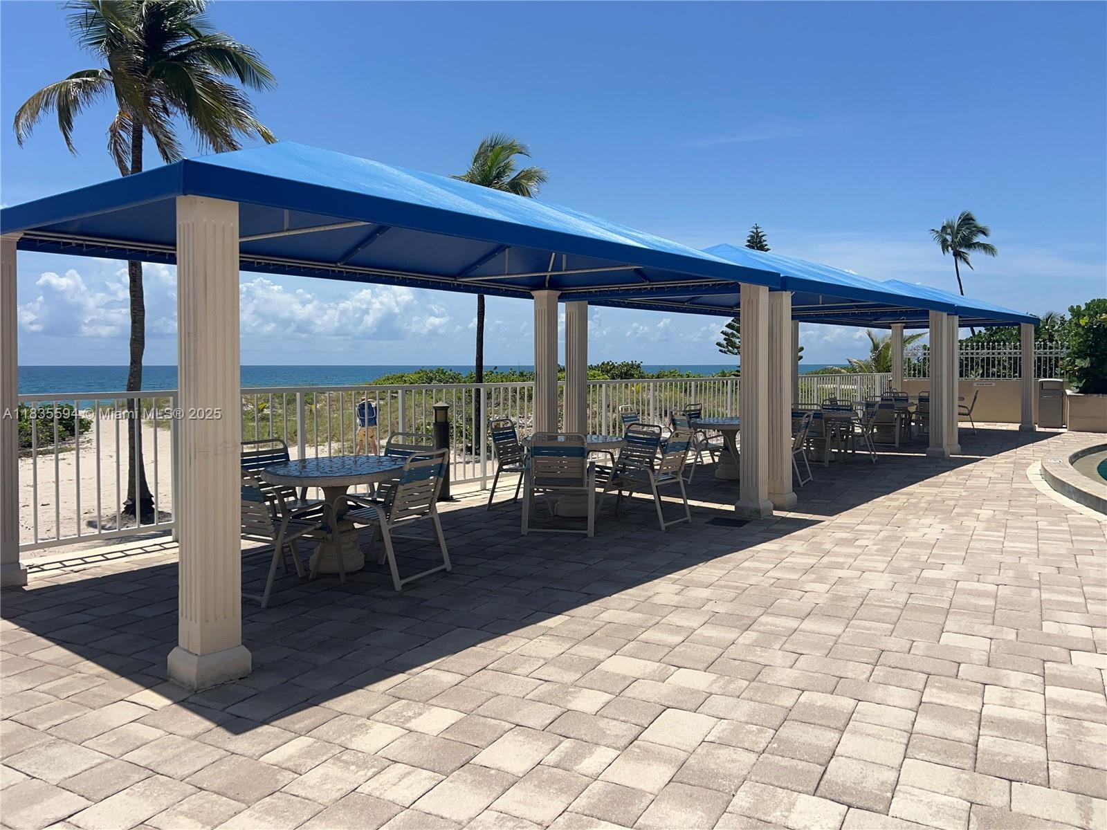 2000 South Ocean Boulevard, Unit 16P Lauderdale-by-the-Sea, FL 33062 - Photo 28 of 31 a outdoor space with lots of tables a large window and chairs