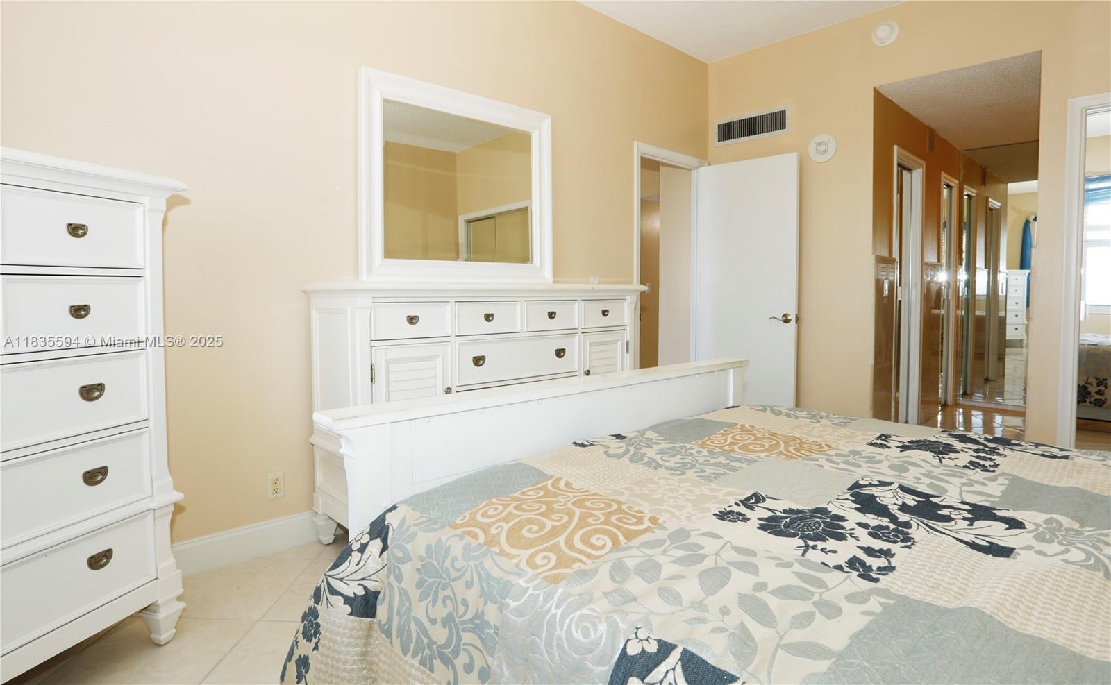 2000 South Ocean Boulevard, Unit 16P Lauderdale-by-the-Sea, FL 33062 - Photo 10 of 31 a bedroom with a bed and a dresser