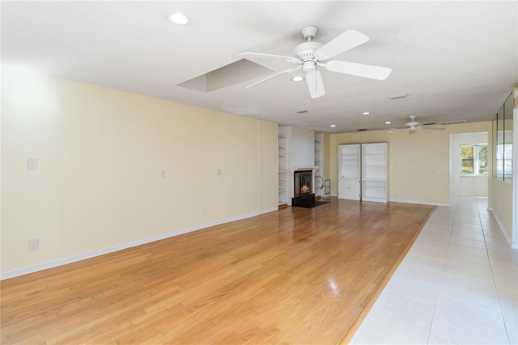 924 Wald Road Orlando, FL 32806 - Photo 14 of 66 an empty room with wooden floor and ceiling fan