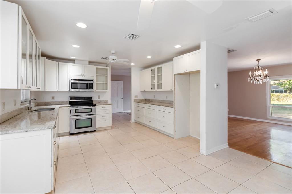 924 Wald Road Orlando, FL 32806 - Photo 17 of 66 a kitchen with stainless steel appliances a refrigerator sink and cabinets