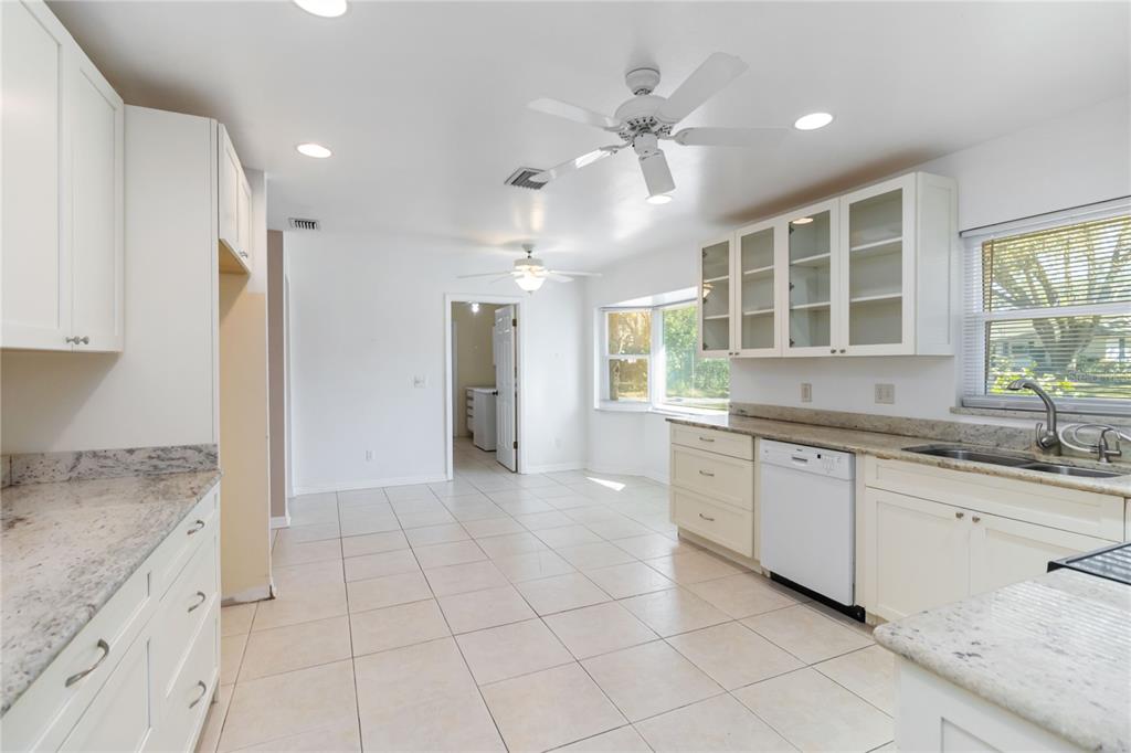 924 Wald Road Orlando, FL 32806 - Photo 18 of 66 a large kitchen with granite countertop a sink and cabinets
