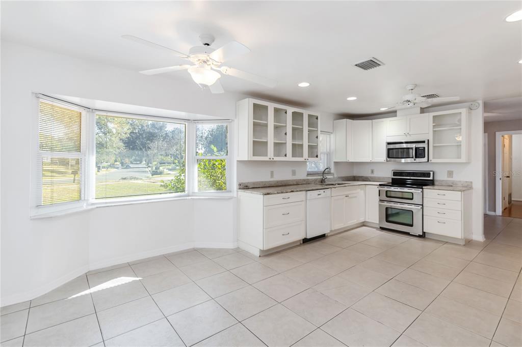 924 Wald Road Orlando, FL 32806 - Photo 21 of 66 a kitchen with a stove a sink and a microwave