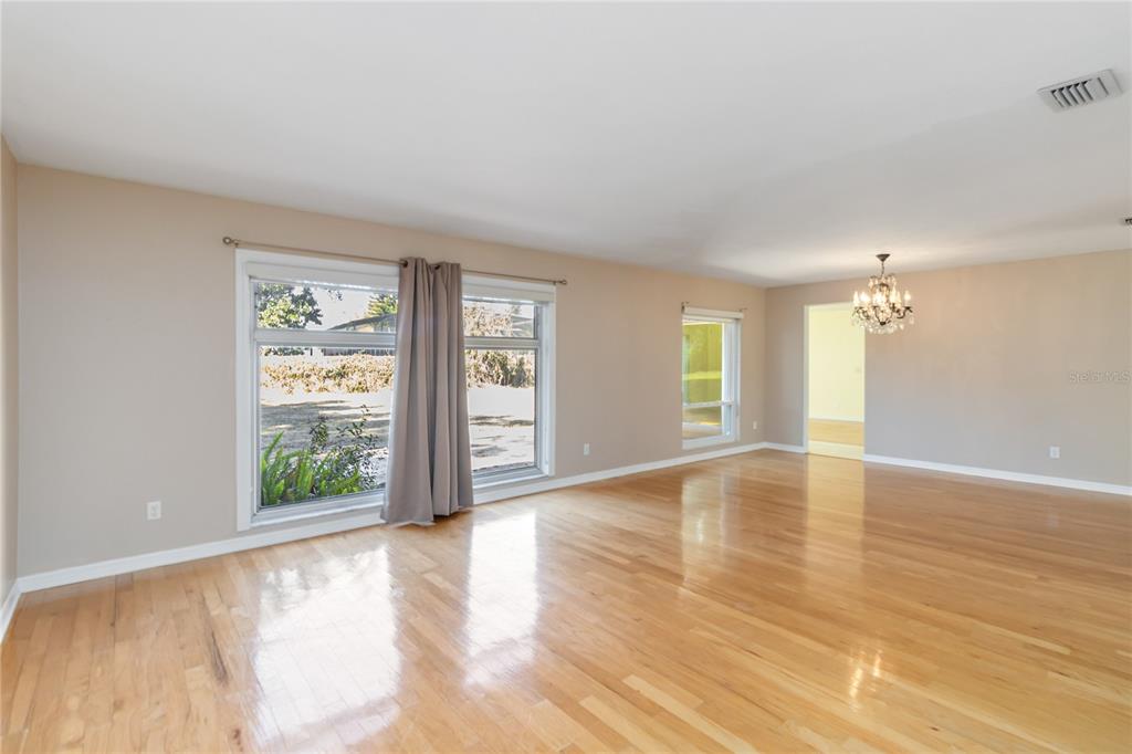 924 Wald Road Orlando, FL 32806 - Photo 10 of 66 an empty room with wooden floor and windows