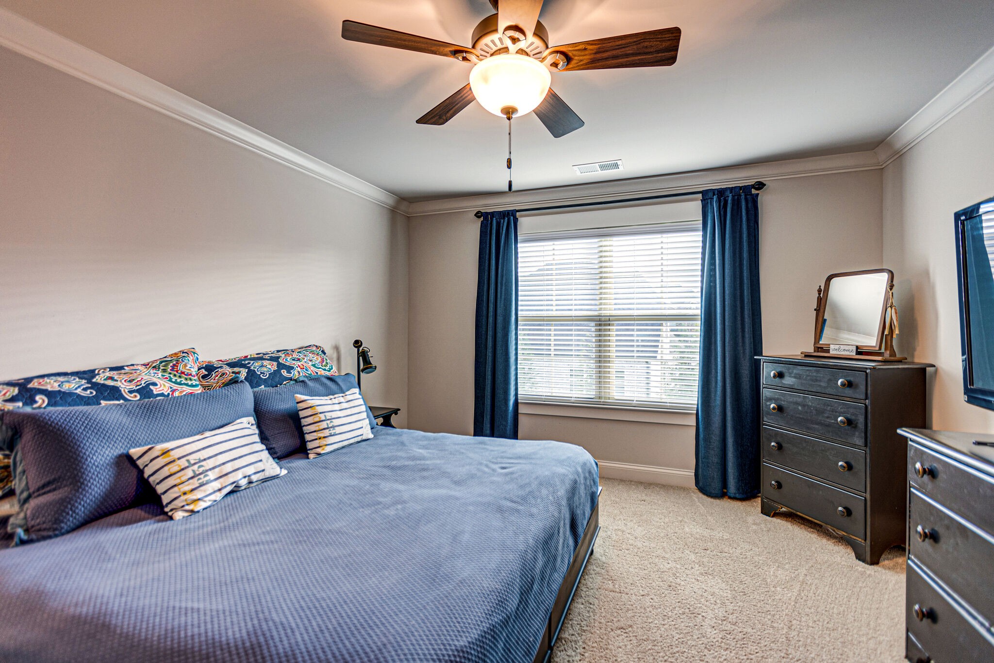 6005 Canberra Court Spring Hill, TN 37174 - Photo 33 of 55 a bedroom with a large bed and a chandelier