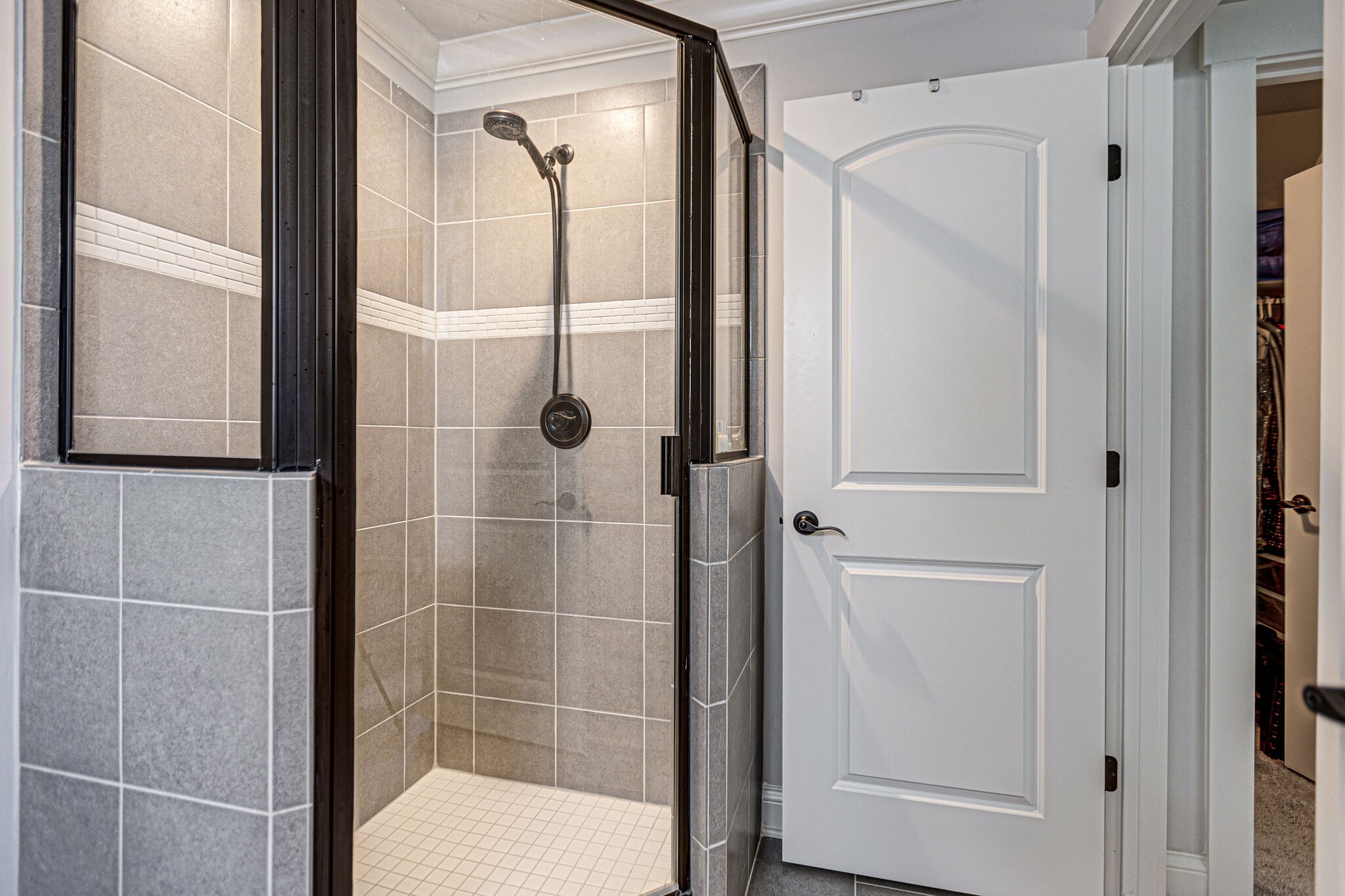 6005 Canberra Court Spring Hill, TN 37174 - Photo 35 of 55 a bathroom with a glass shower door and a mirror
