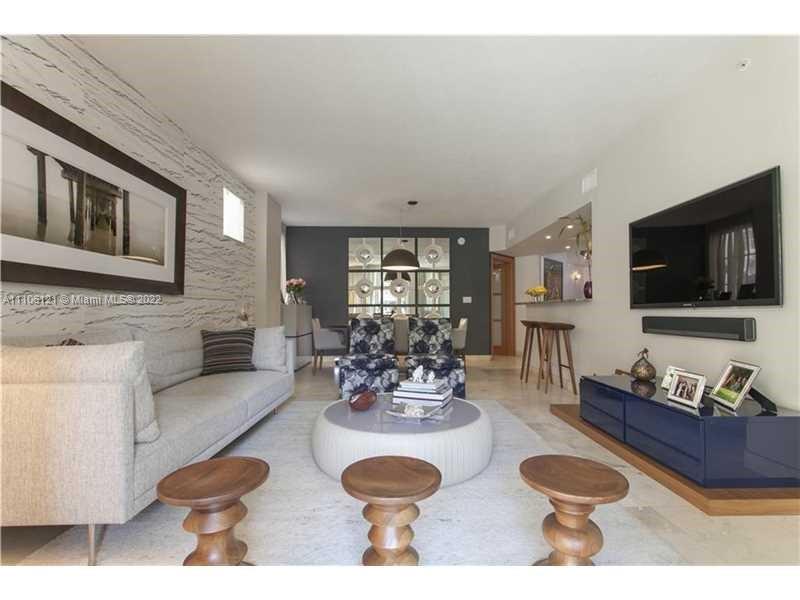 140 Meridian Avenue, Unit 315 Miami Beach, FL 33139 - Photo 1 of 1 a living room with furniture a flat screen tv and kitchen view