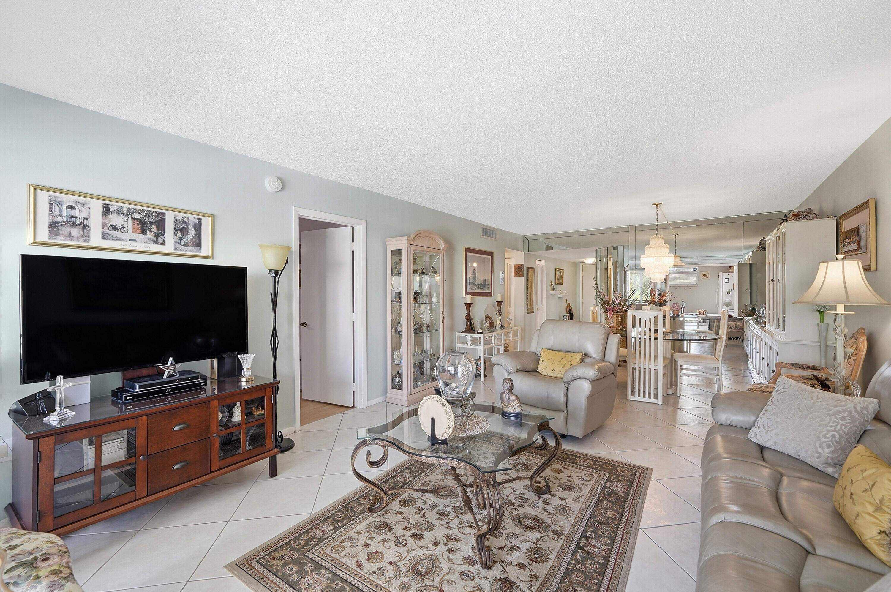 3920 Inverrary Boulevard, Unit 403C Lauderhill, FL 33319 - Photo 14 of 29 a living room with furniture and a flat screen tv