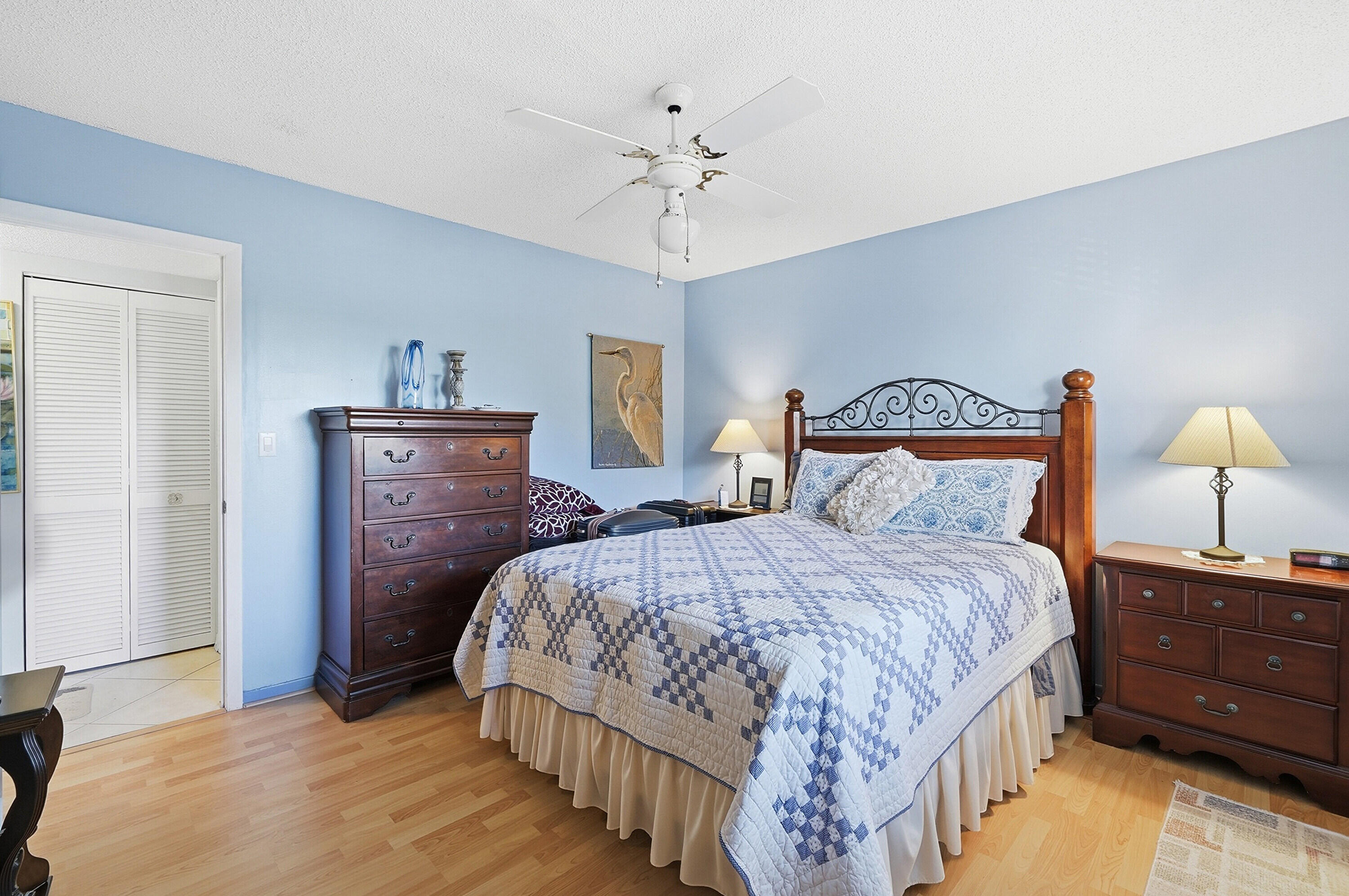 3920 Inverrary Boulevard, Unit 403C Lauderhill, FL 33319 - Photo 16 of 29 a bedroom with a bed and a chandelier