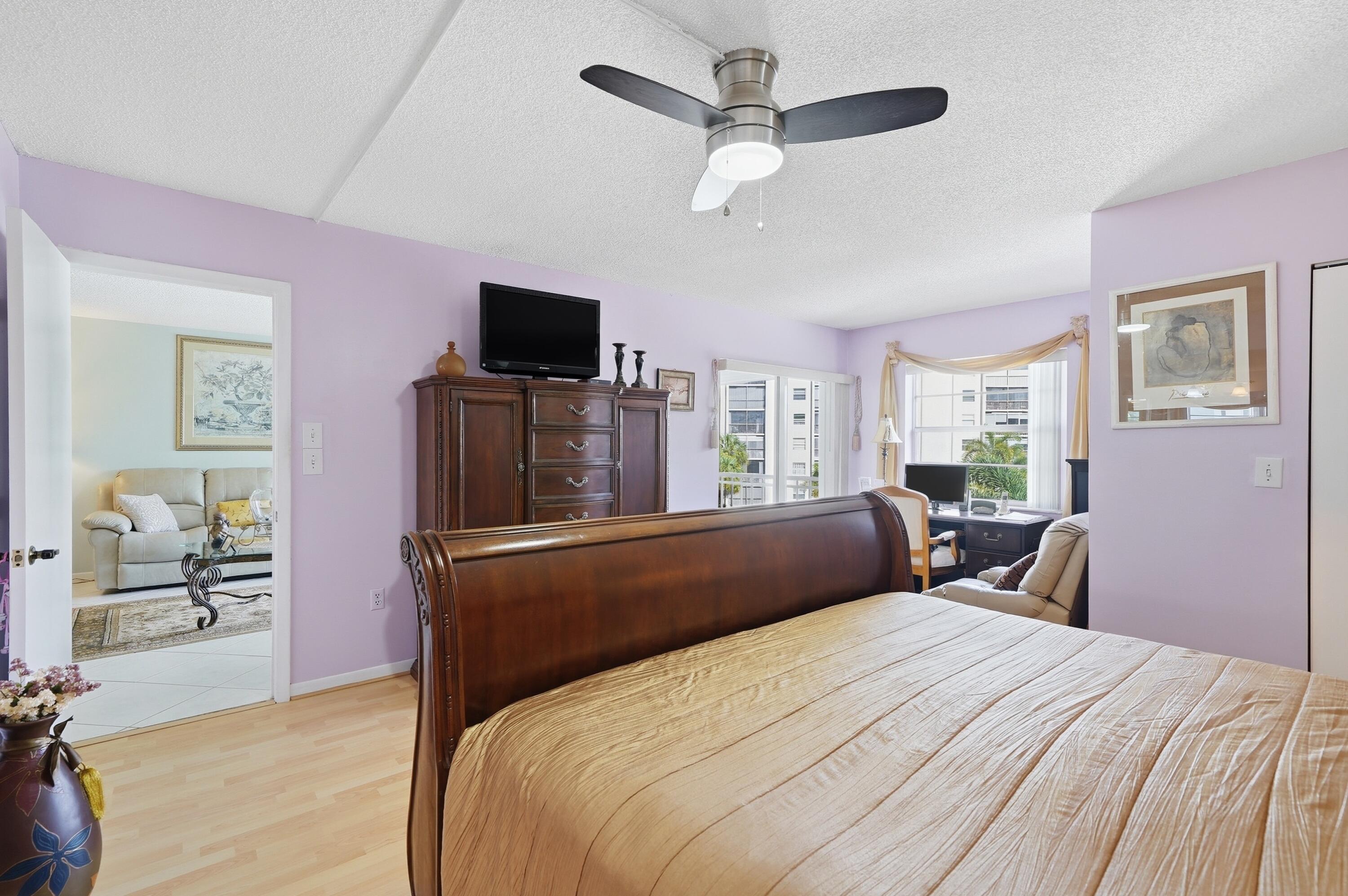 3920 Inverrary Boulevard, Unit 403C Lauderhill, FL 33319 - Photo 19 of 29 a bedroom with a bed and a flat screen tv