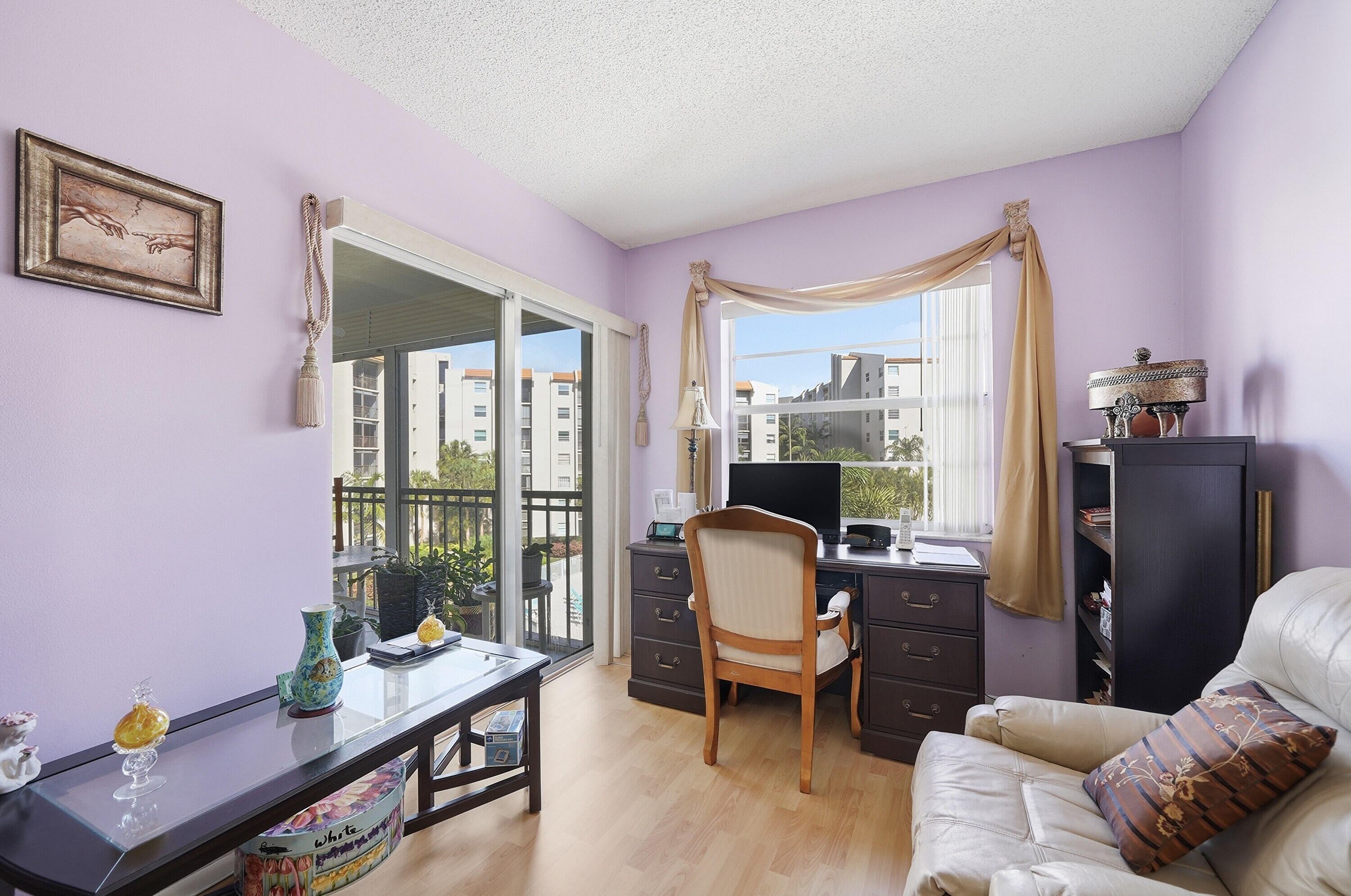 3920 Inverrary Boulevard, Unit 403C Lauderhill, FL 33319 - Photo 20 of 29 a living room with furniture and a floor to ceiling window