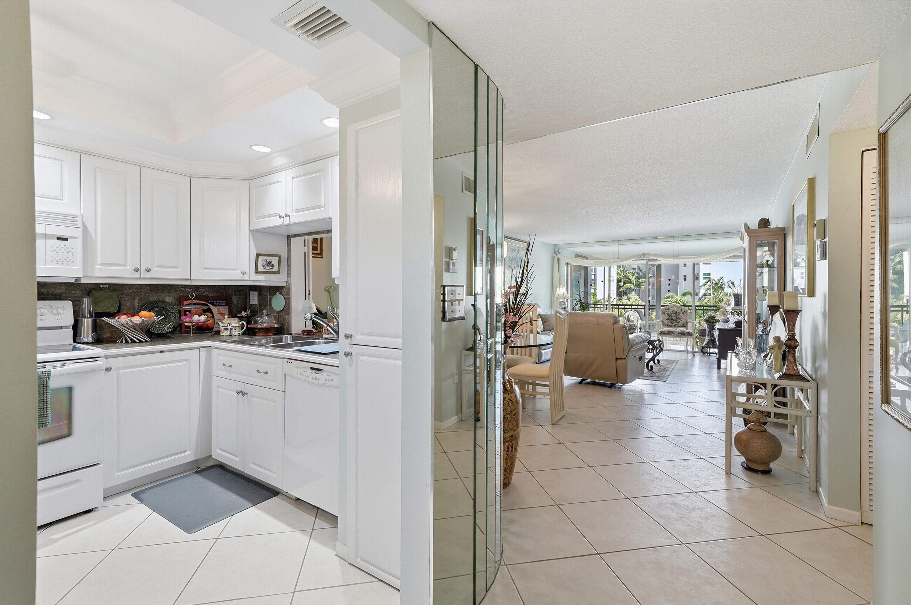 3920 Inverrary Boulevard, Unit 403C Lauderhill, FL 33319 - Photo 5 of 29 a kitchen with granite countertop lots of white cabinets and stainless steel appliances