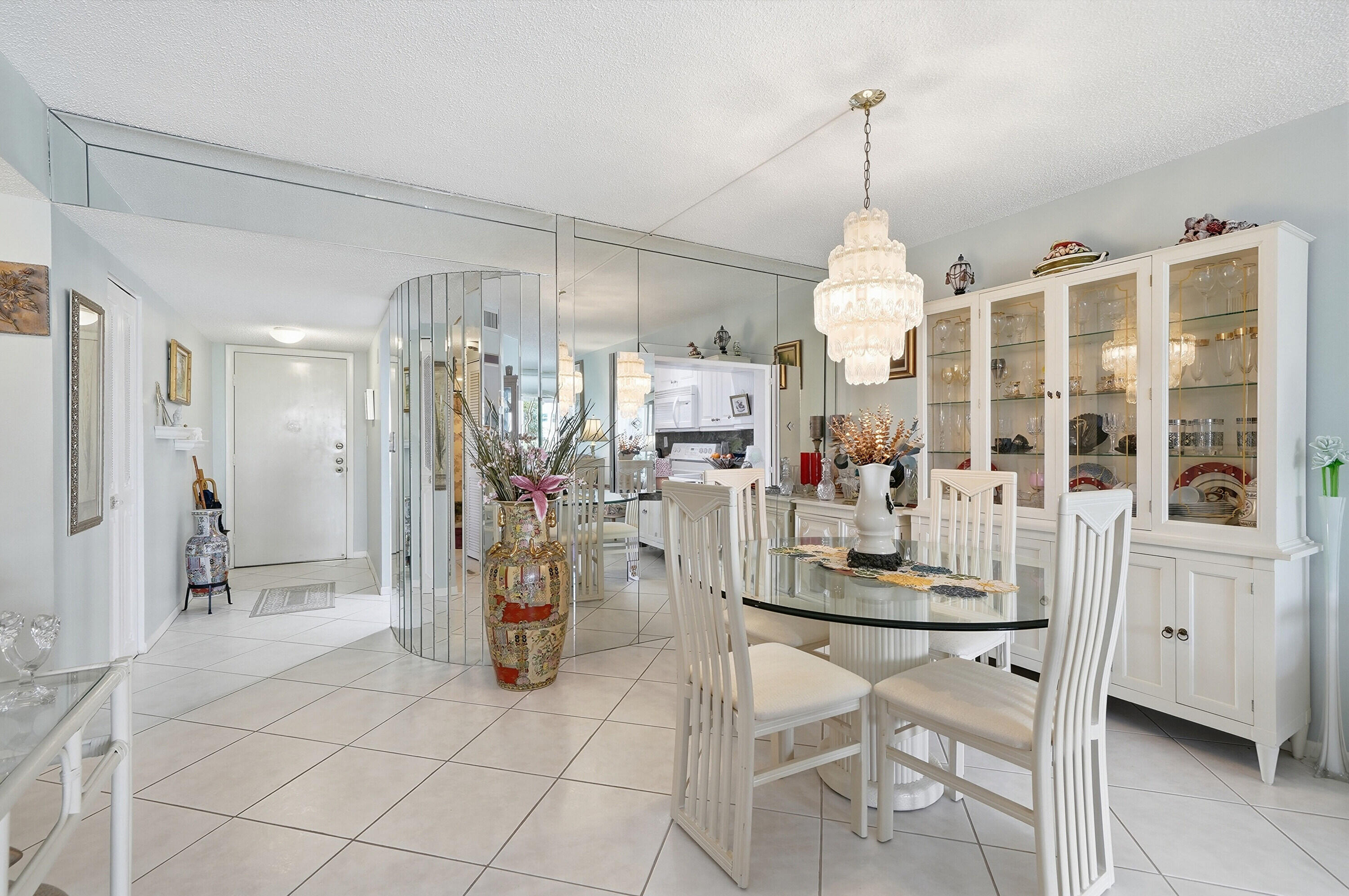 3920 Inverrary Boulevard, Unit 403C Lauderhill, FL 33319 - Photo 10 of 29 a dining room filled with furniture and a chandelier