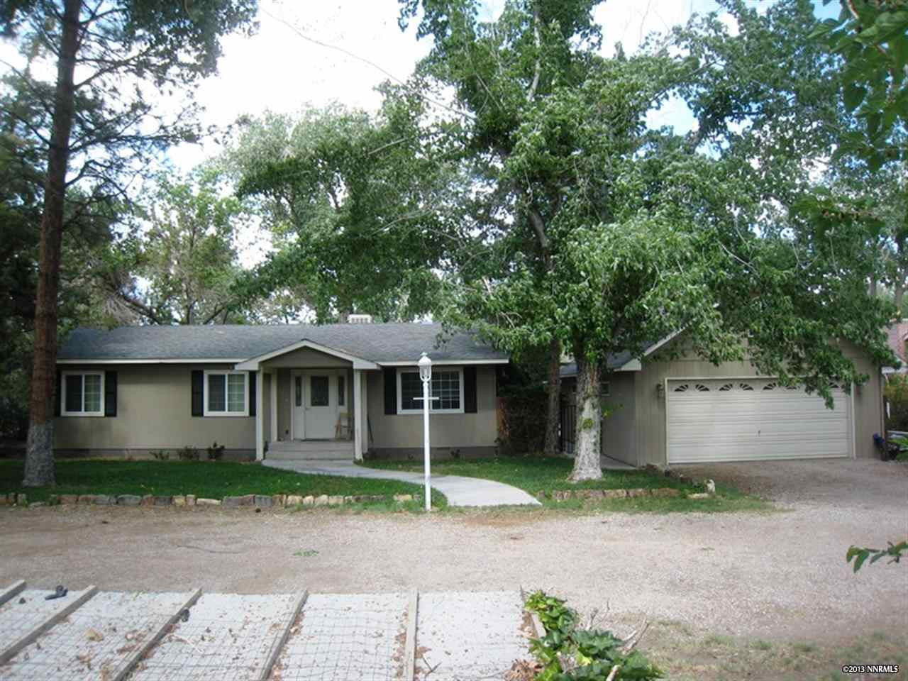 875 McLean Road Fallon, NV 89406 - Photo 1 of 1 a front view of a house with a garden