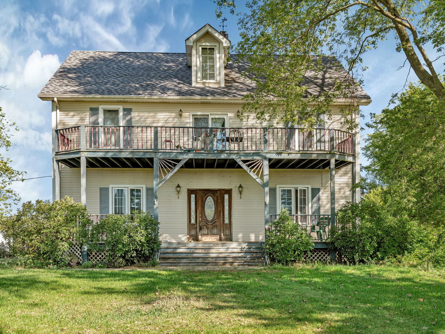 a front view of a house with a garden and plants