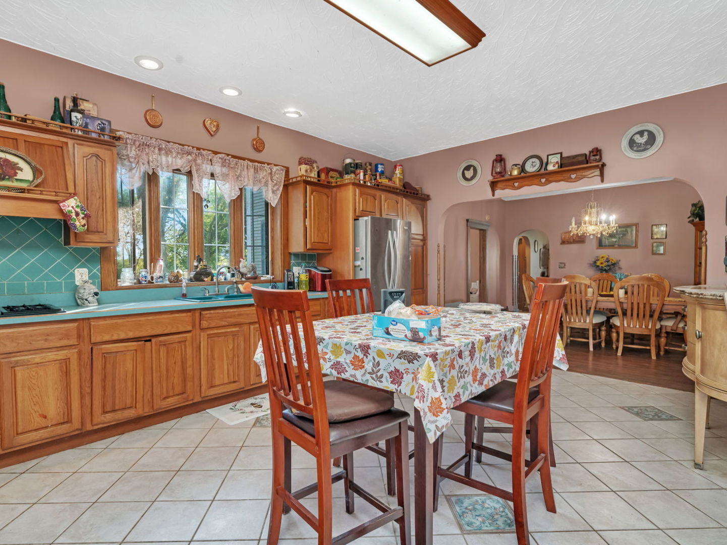 7140 East Huston Road Braceville, IL 60407 - Photo 12 of 34 a dining area with stainless steel appliances granite countertop a dining table and chairs