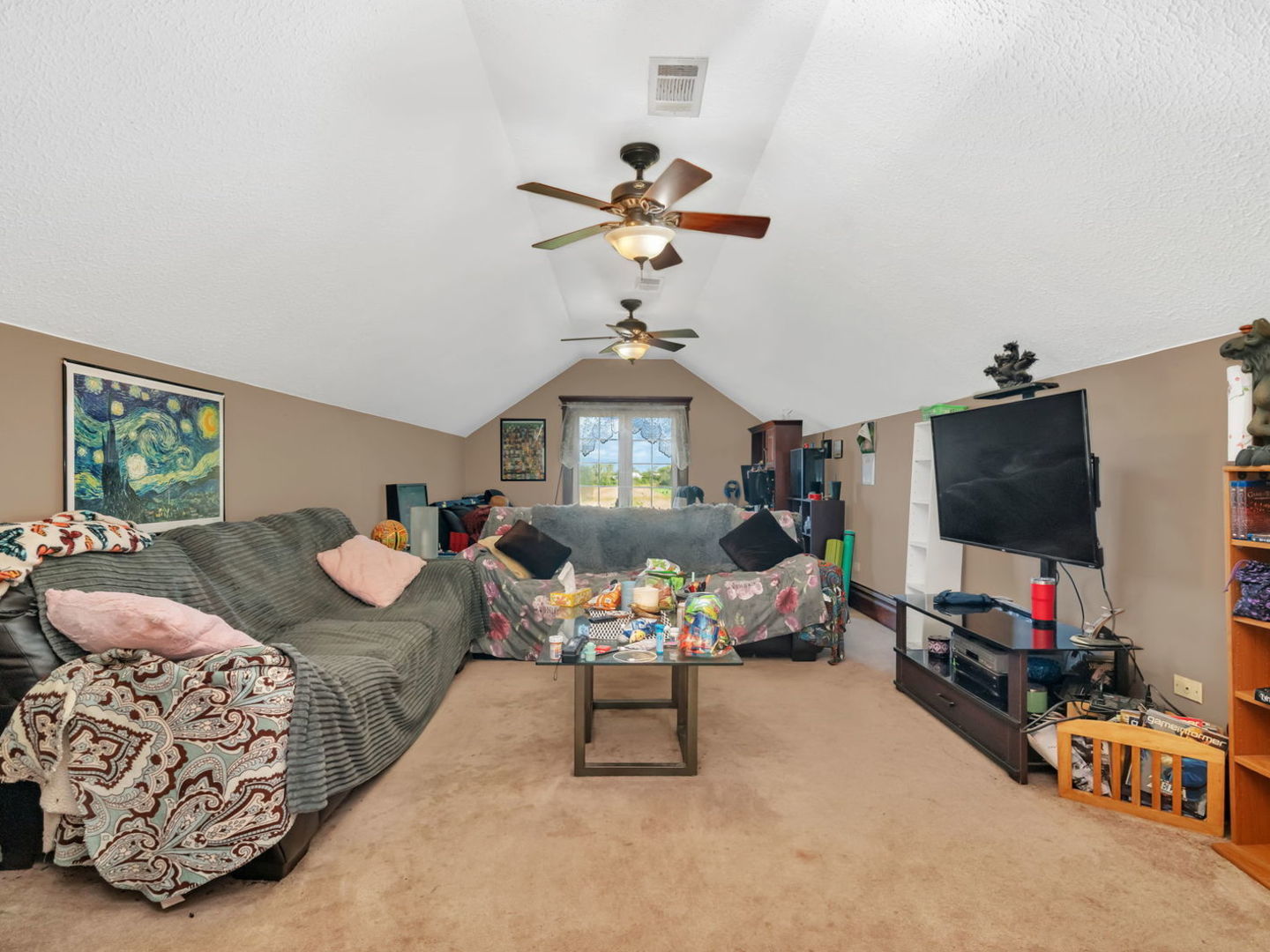 7140 East Huston Road Braceville, IL 60407 - Photo 18 of 34 a bedroom with furniture and a flat screen tv