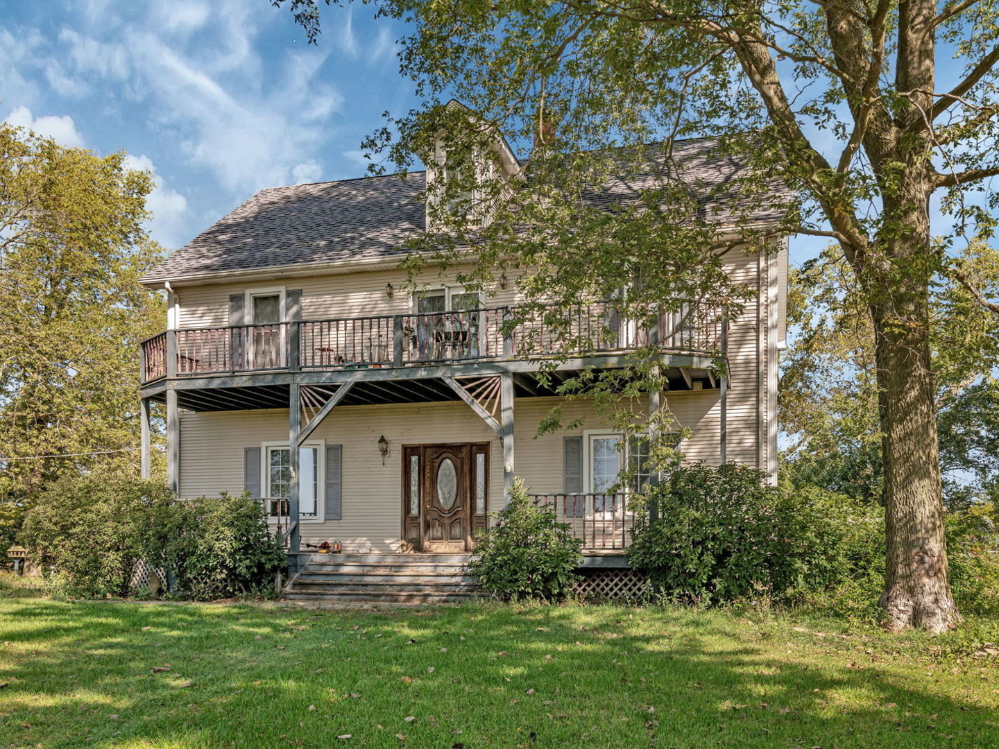 7140 East Huston Road Braceville, IL 60407 - Photo 3 of 34 a front view of a house with a garden