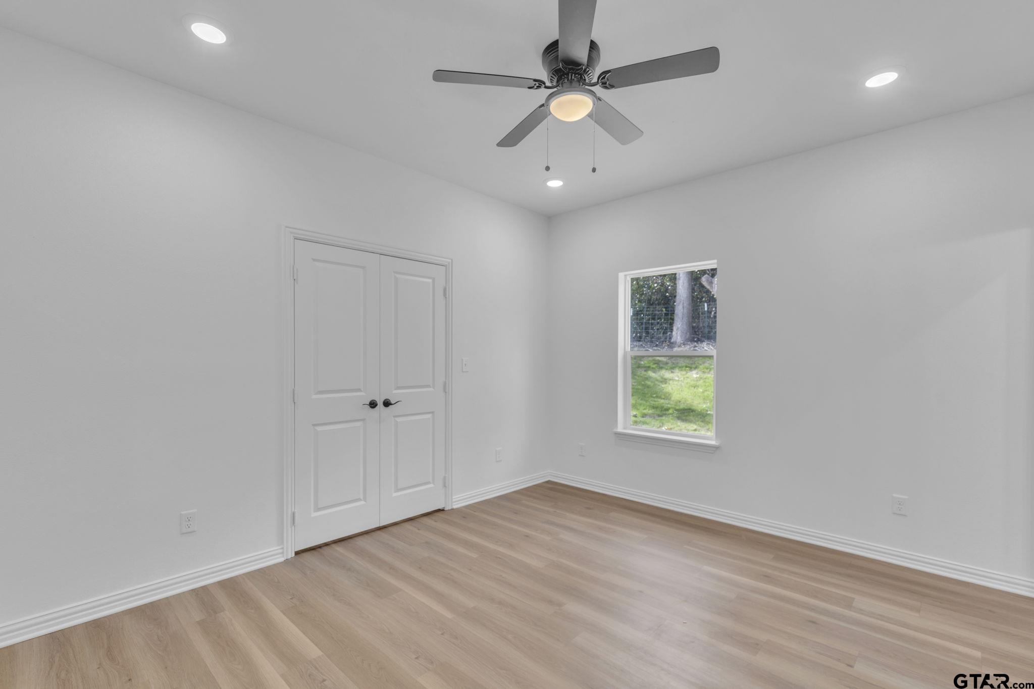 1410 West Connally Street Tyler, TX 75701 - Photo 17 of 29 an empty room with a window and a ceiling fan