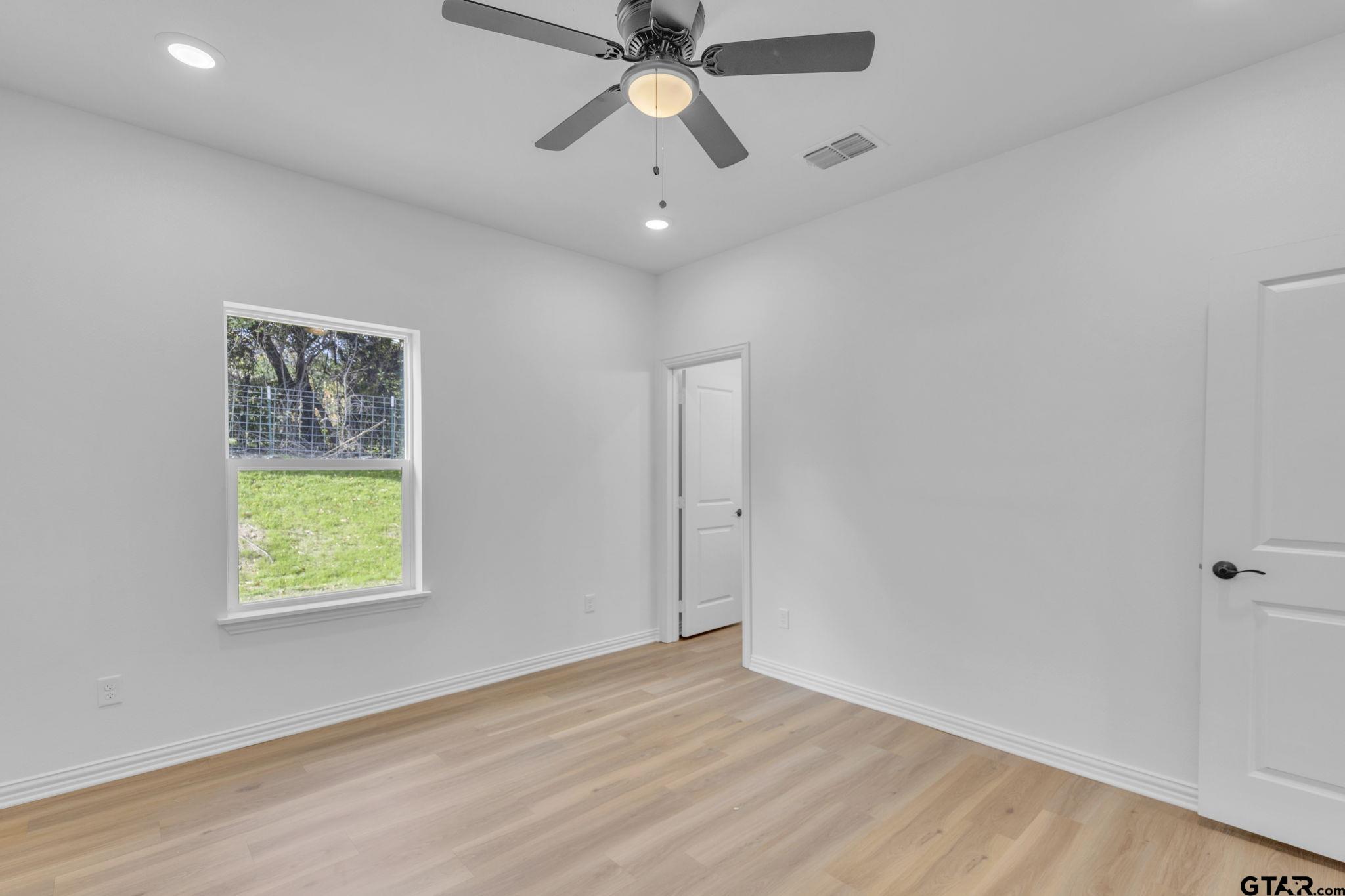 1410 West Connally Street Tyler, TX 75701 - Photo 18 of 29 wooden floor in an empty room with a window