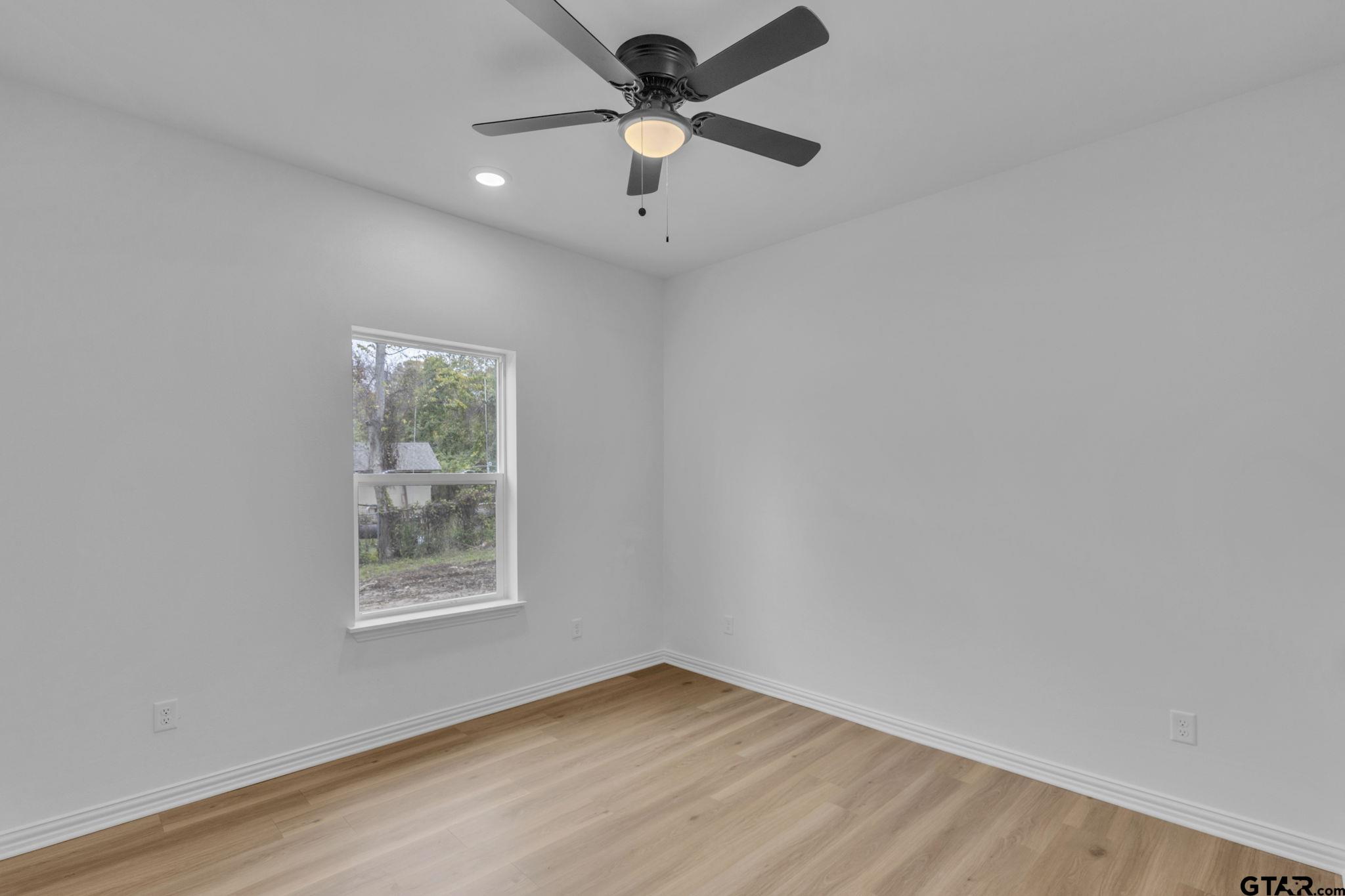 1410 West Connally Street Tyler, TX 75701 - Photo 21 of 29 an empty room with a window and a fan