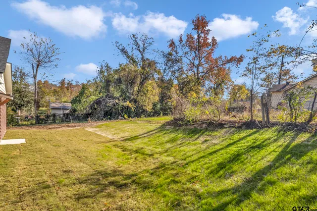 a view of swimming pool of water with yard and seating area
