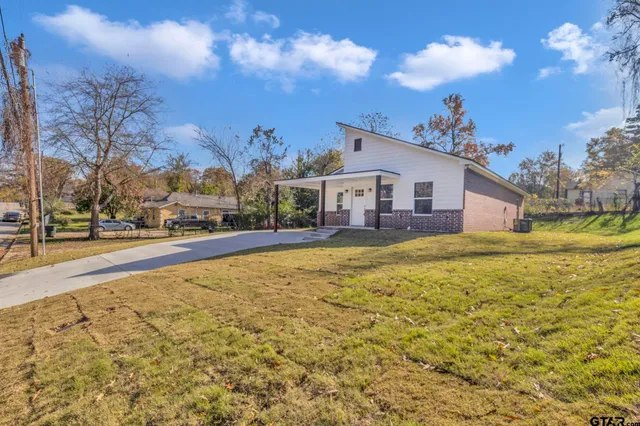 a house view with swimming pool in front of it