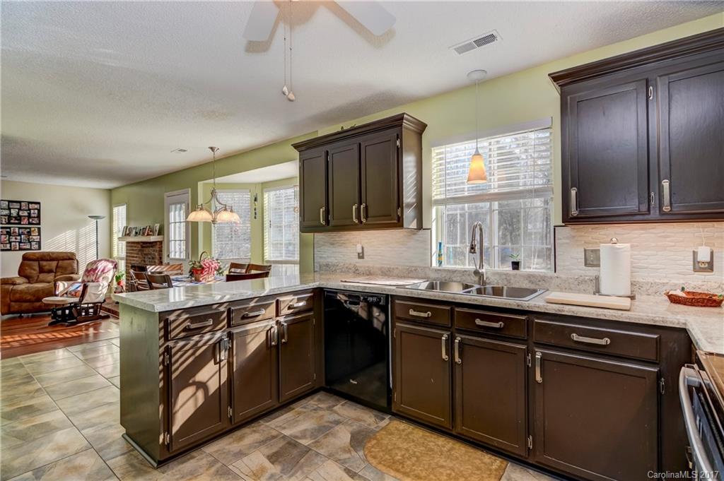 2206 Killarney Place Charlotte, NC 28262 - Photo 11 of 23 a kitchen with a sink stove top oven and cabinets