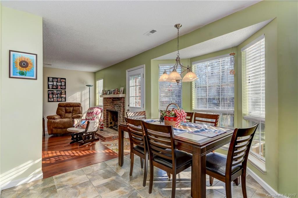 2206 Killarney Place Charlotte, NC 28262 - Photo 12 of 23 a dining room with furniture a chandelier and wooden floor