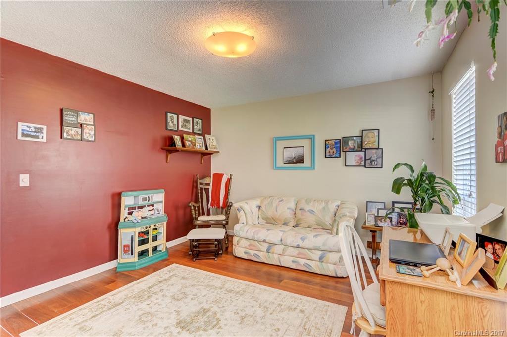 2206 Killarney Place Charlotte, NC 28262 - Photo 14 of 23 a bedroom with furniture and a wooden floor