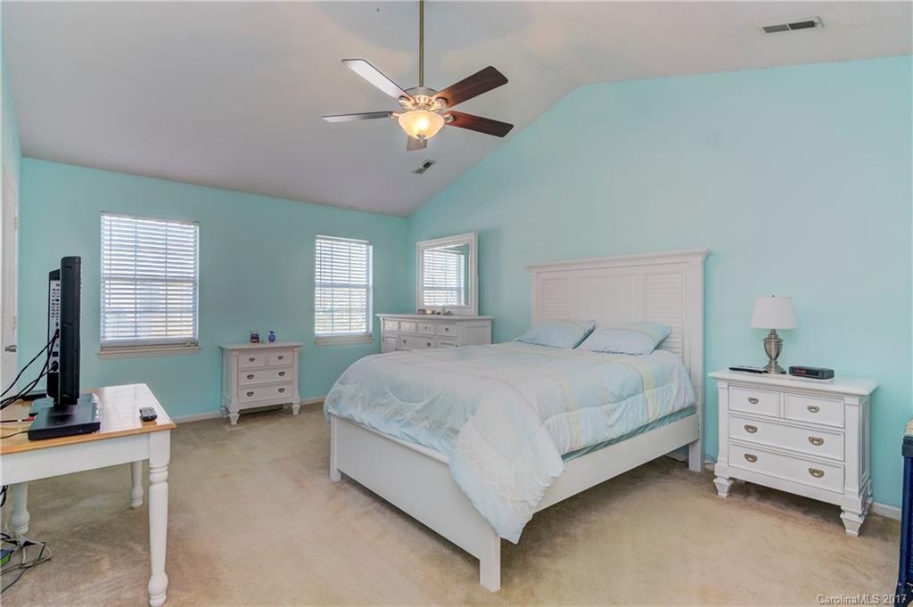 2206 Killarney Place Charlotte, NC 28262 - Photo 16 of 23 a bedroom with a bed and a chandelier