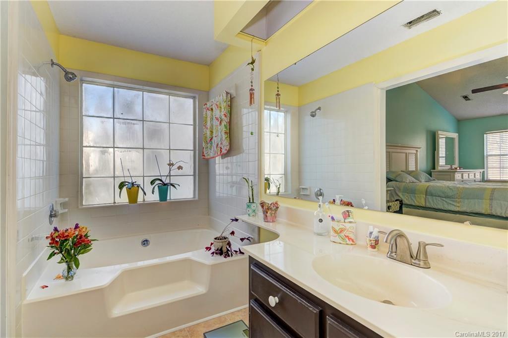 2206 Killarney Place Charlotte, NC 28262 - Photo 17 of 23 a bathroom with a tub sink and mirror