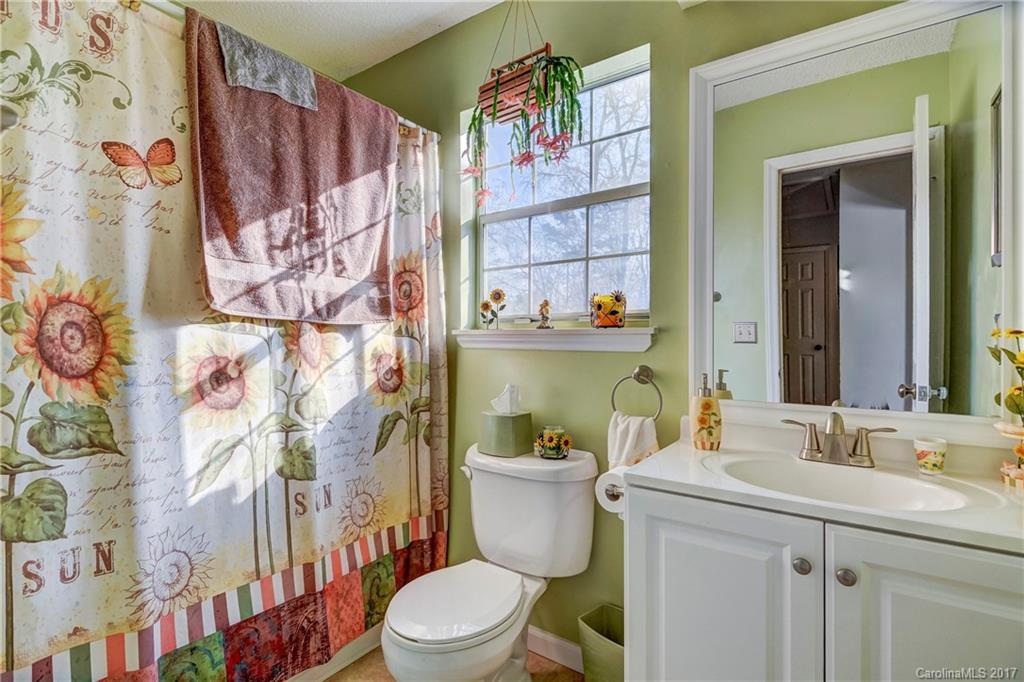 2206 Killarney Place Charlotte, NC 28262 - Photo 19 of 23 a bathroom with a toilet sink and mirror