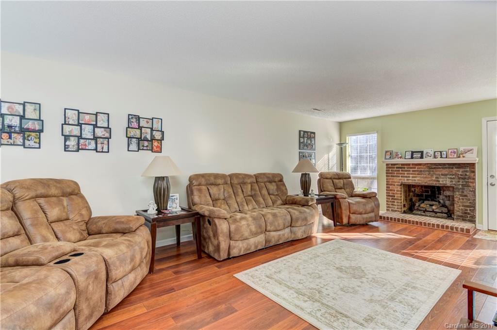 2206 Killarney Place Charlotte, NC 28262 - Photo 4 of 23 a living room with furniture and a fireplace