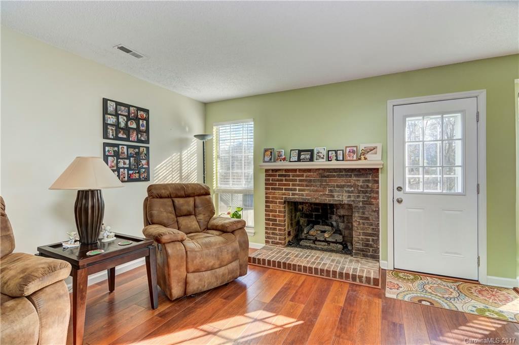 2206 Killarney Place Charlotte, NC 28262 - Photo 6 of 23 a living room with furniture and a fireplace