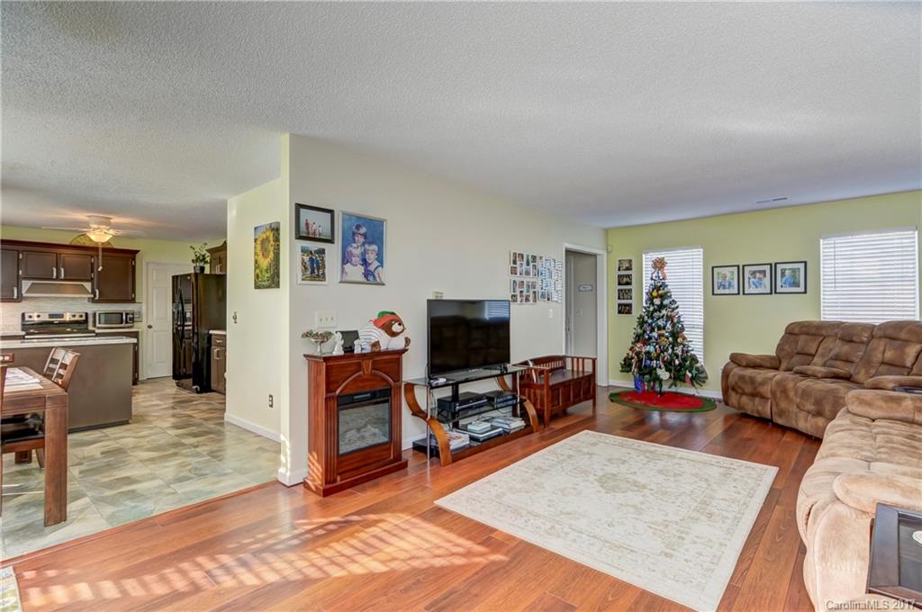 2206 Killarney Place Charlotte, NC 28262 - Photo 7 of 23 a living room with furniture and a flat screen tv