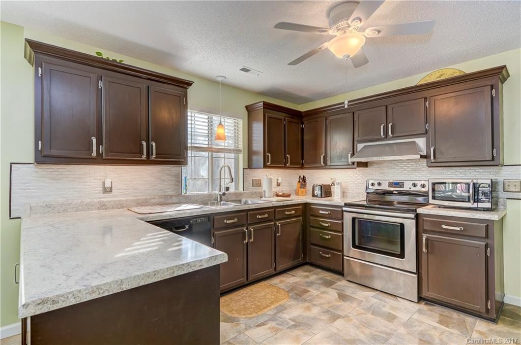2206 Killarney Place Charlotte, NC 28262 - Photo 10 of 23 a kitchen with a sink stove and microwave