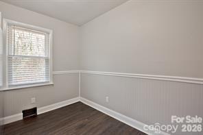 1404 Nottingham Road Kannapolis, NC 28081 - Photo 11 of 30 a view of an empty room with wooden floor and a window