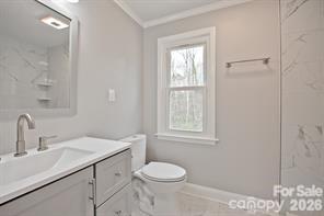 1404 Nottingham Road Kannapolis, NC 28081 - Photo 24 of 30 a bathroom with a sink toilet and window