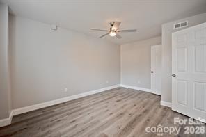 1404 Nottingham Road Kannapolis, NC 28081 - Photo 25 of 30 an empty room with wooden floor fan and windows