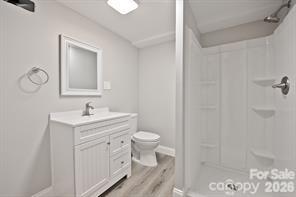 1404 Nottingham Road Kannapolis, NC 28081 - Photo 26 of 30 a bathroom with a toilet sink vanity and mirror