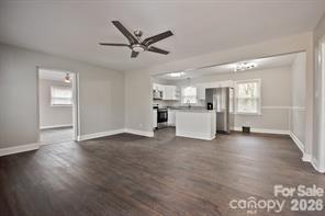 1404 Nottingham Road Kannapolis, NC 28081 - Photo 5 of 30 a view of a kitchen with a sink dishwasher cabinets and wooden floor