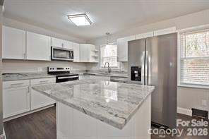 1404 Nottingham Road Kannapolis, NC 28081 - Photo 8 of 30 a kitchen with kitchen island granite countertop a refrigerator a sink a stove a microwave a counter top space and cabinets